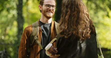 Student on the Berlin campus smiling and talking to a classmate